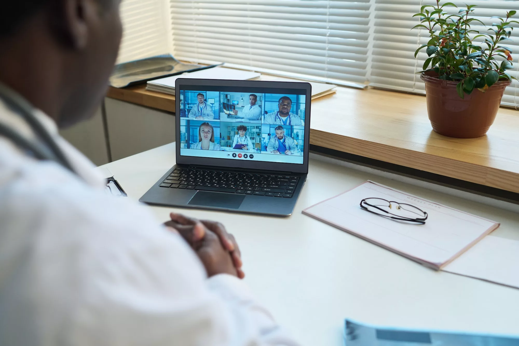 Focus on laptop screen with group of intercultural virtual health assistants